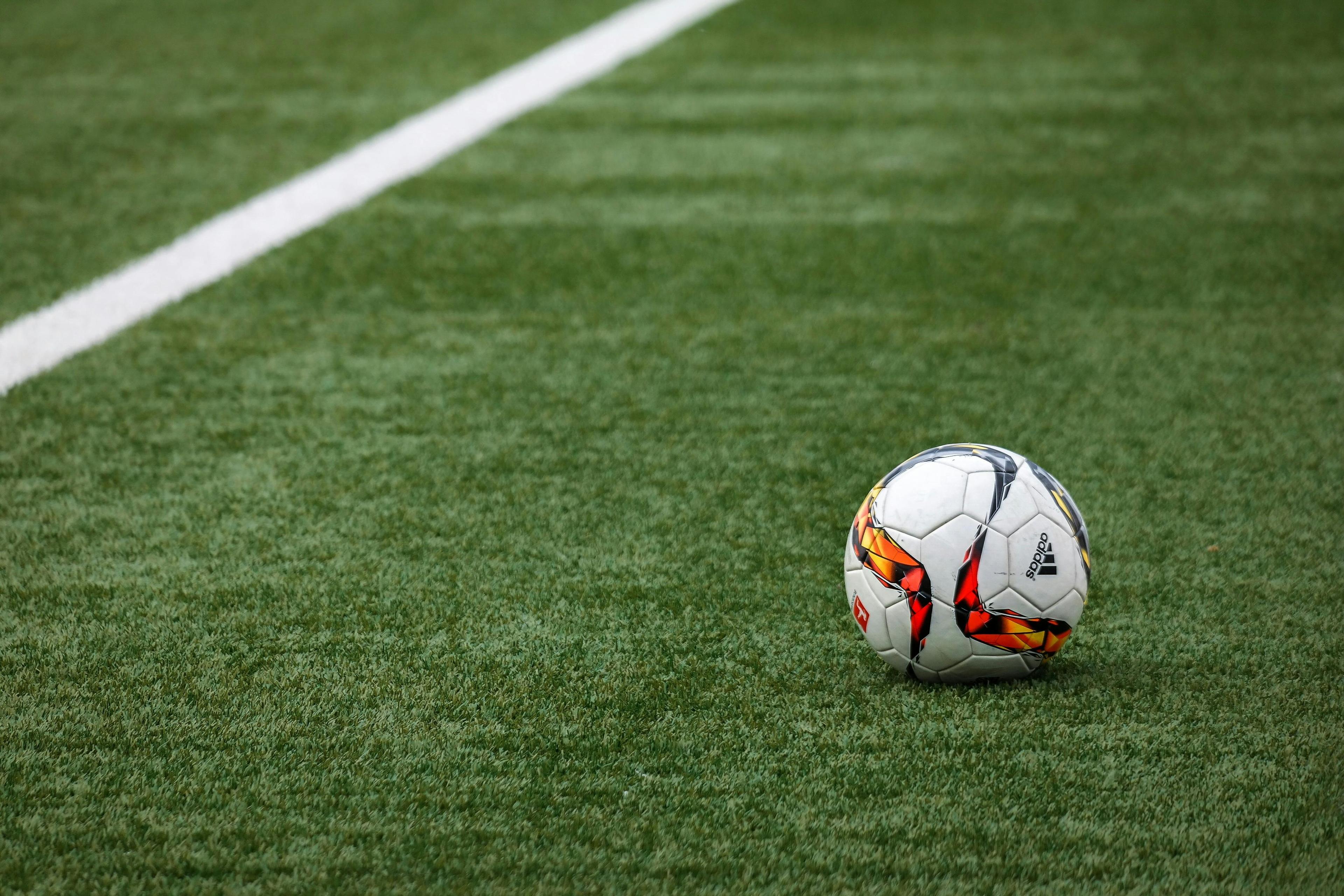 Soccer field with a ball resting on the grass